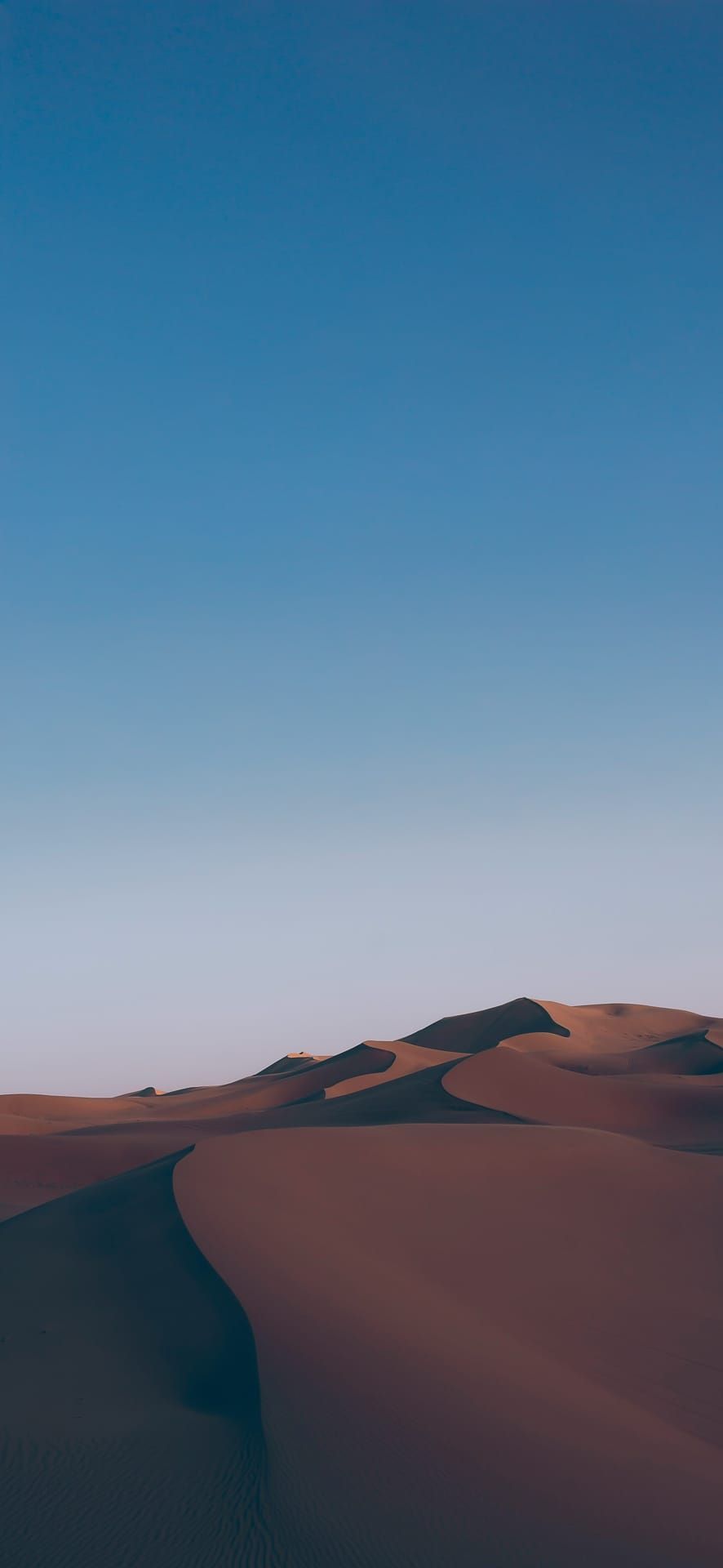 Golden sand dunes in the Sahara Desert under a clear blue sky, showcasing abstract textures and minimalist nature for Phone Wallpaper.